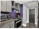 Contemporary kitchen with gray cabinetry, stainless appliances, and purple backsplash at 9000 S Las Vegas Blvd # 2222, Las Vegas, NV 89123