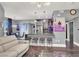 Open-concept living room with modern lighting, sleek furniture, and a stylish kitchen area with bar seating at 9000 S Las Vegas Blvd # 2222, Las Vegas, NV 89123