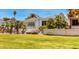 Spacious backyard with a well-manicured lawn, mature palm trees, and patio at 940 Vegas Valley Dr, Las Vegas, NV 89109