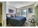 Comfortable bedroom with a queen-size bed, a chair, and natural light, creating a peaceful retreat at 940 Vegas Valley Dr, Las Vegas, NV 89109