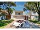Charming two-story home with a well-manicured lawn and a luxury sports car in the driveway at 940 Vegas Valley Dr, Las Vegas, NV 89109