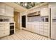 A clean, galley-style kitchen with white cabinets and a unique mirrored ceiling at 940 Vegas Valley Dr, Las Vegas, NV 89109