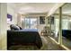 Bedroom featuring a comfortable bed, mirrored closet doors, and natural light at 940 Vegas Valley Dr, Las Vegas, NV 89109