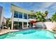 Backyard pool with an outdoor dining area, palm trees, and beautiful landscaping, ready for summer at 940 Vegas Valley Dr, Las Vegas, NV 89109