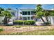 Home's rear exterior boasts a pool and privacy fence, complemented by lush tropical landscaping at 940 Vegas Valley Dr, Las Vegas, NV 89109