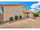 Backyard with a covered patio area, brick accents, and lush greenery, offering an inviting outdoor space at 9588 Comiskey Ct, Las Vegas, NV 89148