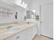 Well-lit bathroom featuring double sinks and white cabinets at 9588 Comiskey Ct, Las Vegas, NV 89148