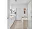Bathroom featuring double sinks, a tub, and a glass-enclosed shower at 9588 Comiskey Ct, Las Vegas, NV 89148