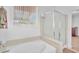 Bathroom featuring a soaking tub and glass-enclosed shower at 9588 Comiskey Ct, Las Vegas, NV 89148