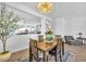 Dining area leading to living spaces, featuring wood floors, natural light, and decorative accents at 9588 Comiskey Ct, Las Vegas, NV 89148