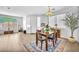 Bright dining area with wood floors and a decorative rug and vintage light fixture at 9588 Comiskey Ct, Las Vegas, NV 89148