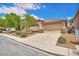 A single-story home with a tiled roof, two-car garage, and a low-maintenance front yard on a sunny day at 9588 Comiskey Ct, Las Vegas, NV 89148