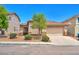 Cozy single-story home with a tile roof, desert landscaping, and attached two-car garage at 9588 Comiskey Ct, Las Vegas, NV 89148