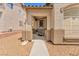 Inviting front entryway with a decorative security door, textured stucco walls and desert landscaping at 9588 Comiskey Ct, Las Vegas, NV 89148