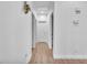 Clean hallway with wood flooring, white walls, and access to multiple rooms in the house at 9588 Comiskey Ct, Las Vegas, NV 89148