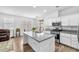 Bright kitchen featuring white cabinets, granite countertops, and a kitchen island with sink at 9588 Comiskey Ct, Las Vegas, NV 89148