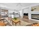 Bright living room with fireplace, wood floors, and open access to the kitchen and outside patio at 9588 Comiskey Ct, Las Vegas, NV 89148