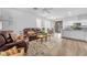 Spacious living room featuring a leather sofa set, laminate flooring, and open layout at 9588 Comiskey Ct, Las Vegas, NV 89148