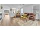 Bright living room featuring an open floor plan with wood flooring and comfortable leather seating at 9588 Comiskey Ct, Las Vegas, NV 89148