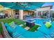 A beautiful outdoor space with a pool, lounge area, patio, and a barbeque grill at 9858 Gemstone Sunset Ave, Las Vegas, NV 89148