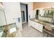 This bathroom features a double sink, granite countertop and a doorway leading to the shower at 9858 Gemstone Sunset Ave, Las Vegas, NV 89148
