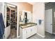 Bathroom featuring granite counters, walk-in closet, and ample lighting at 9858 Gemstone Sunset Ave, Las Vegas, NV 89148