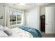 Bright bedroom featuring a large window, closet, and comfortable decor at 9858 Gemstone Sunset Ave, Las Vegas, NV 89148