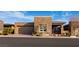 Contemporary home featuring a stone facade, well-manicured landscaping, and a two-car garage at 9858 Gemstone Sunset Ave, Las Vegas, NV 89148