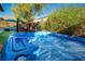 Inviting hot tub surrounded by lush greenery and comfortable lounge seating at 9858 Gemstone Sunset Ave, Las Vegas, NV 89148