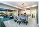 Bright kitchen featuring a large island with quartz countertops, white cabinetry and backyard access at 9858 Gemstone Sunset Ave, Las Vegas, NV 89148