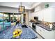 Beautiful kitchen featuring stylish granite countertops, tile backsplash, and backyard access at 9858 Gemstone Sunset Ave, Las Vegas, NV 89148