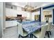 Spacious kitchen featuring custom backsplash, quartz countertops, white cabinets and stainless appliances at 9858 Gemstone Sunset Ave, Las Vegas, NV 89148