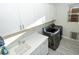Bright laundry room with modern washer/dryer units and ample cabinet space at 9858 Gemstone Sunset Ave, Las Vegas, NV 89148