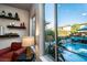 Bright living room with large windows overlooking the pool and patio area at 9858 Gemstone Sunset Ave, Las Vegas, NV 89148