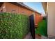 Green side yard with artificial turf, a privacy fence, and decorative outdoor lights at 9858 Gemstone Sunset Ave, Las Vegas, NV 89148