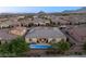 Aerial view of home with pool, patio and solar panels in a neighborhood with mountain views in the distance at 10086 Mountain Foothills Ave, Las Vegas, NV 89149