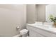 Elegant half bath features white vanity, with floral accents at 10086 Mountain Foothills Ave, Las Vegas, NV 89149