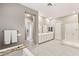This large primary bathroom features a double vanity and tile floors at 10086 Mountain Foothills Ave, Las Vegas, NV 89149