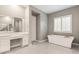 Bright primary bathroom features tile floors, double vanities, a tub, and a separate vanity area at 10086 Mountain Foothills Ave, Las Vegas, NV 89149