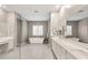 A bright primary bathroom features tile floors, double vanities, a large tub, and a step-in shower at 10086 Mountain Foothills Ave, Las Vegas, NV 89149