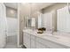 Modern bathroom with dual sinks, vanity, and bathtub with shower at 10086 Mountain Foothills Ave, Las Vegas, NV 89149