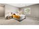 Comfortable bedroom featuring plush gray carpeting, neutral walls, and a decorative tufted headboard at 10086 Mountain Foothills Ave, Las Vegas, NV 89149