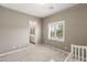 Neutral bedroom with carpet and window, leading to a bathroom at 10086 Mountain Foothills Ave, Las Vegas, NV 89149