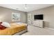 Bright bedroom features an entertainment center, a ceiling fan and a door to the backyard at 10086 Mountain Foothills Ave, Las Vegas, NV 89149