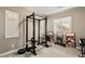 A dedicated home gym features modern weight training equipment and natural light at 10086 Mountain Foothills Ave, Las Vegas, NV 89149