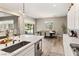 Bright kitchen featuring white cabinets, stainless steel appliances and seamless access to dining and backyard at 10086 Mountain Foothills Ave, Las Vegas, NV 89149