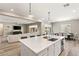 Open concept kitchen featuring an island with a sink, seamlessly connects to the dining and living areas at 10086 Mountain Foothills Ave, Las Vegas, NV 89149