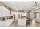 Bright kitchen featuring white cabinets, stainless steel appliances, backsplash, and an island with bar seating at 10086 Mountain Foothills Ave, Las Vegas, NV 89149
