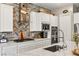 Bright kitchen featuring white cabinets, stainless steel appliances, backsplash, and countertop at 10086 Mountain Foothills Ave, Las Vegas, NV 89149