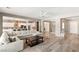 Spacious living room with a large sofa, open to a modern kitchen with stainless steel appliances at 10086 Mountain Foothills Ave, Las Vegas, NV 89149